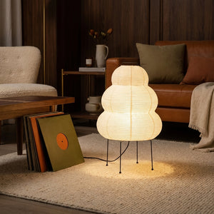 Yuki rice paper lantern lamp on a rug beside vinyl records