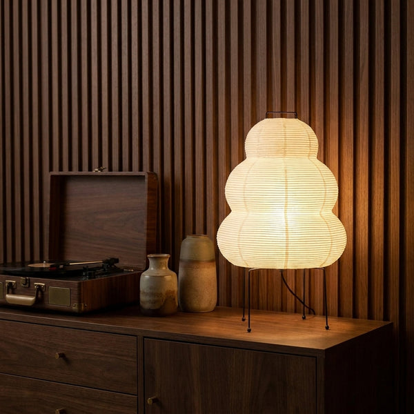 Yuki rice paper lamp on a walnut credenza beside a record player