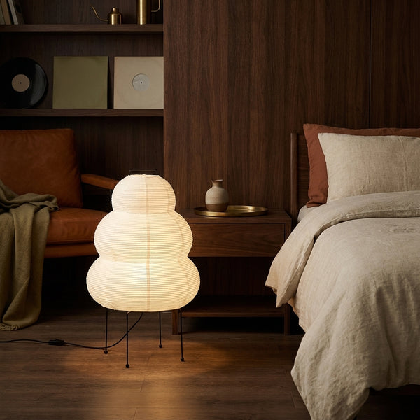 Yuki rice paper lamp next to a walnut nightstand