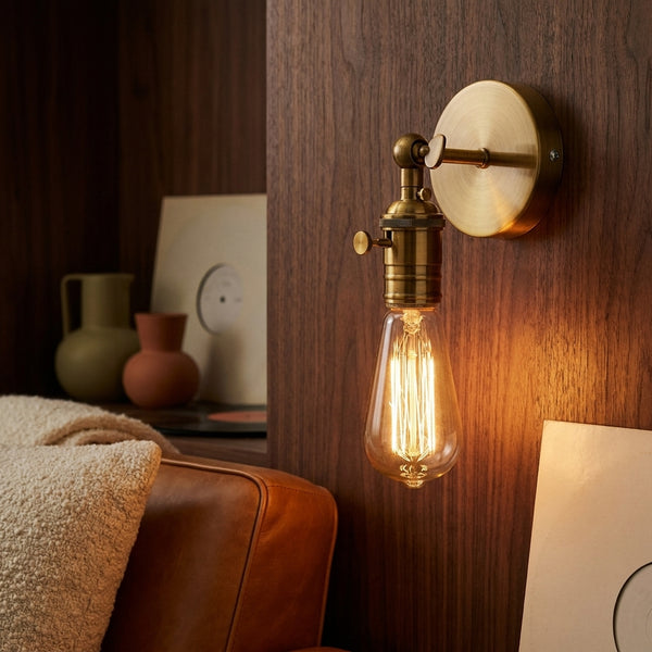 Hayden brass sconce glowing, close up