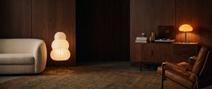 Mid century living room at dusk with the Yuki paper lantern and the Nimbus orange glass table lamp