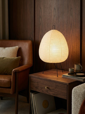 Kumo rice paper lamp glowing on a nightstand