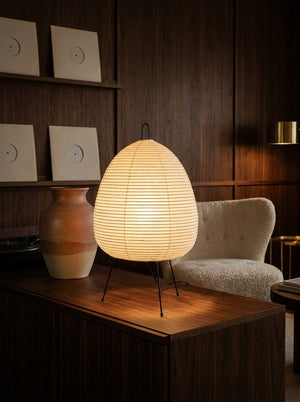 Kumo tripod lamp on a walnut console