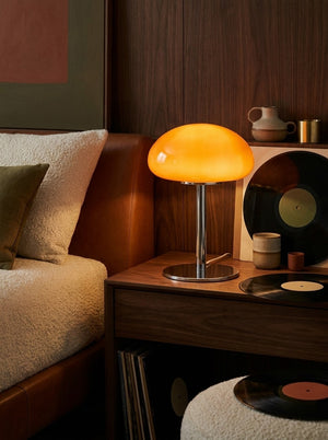 Nimbus cloud glass lamp glowing on a nightstand
