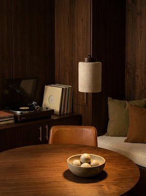 Sora pendant over a round walnut dining table