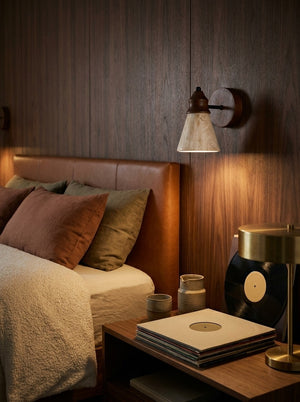 Terra wall sconce beside a bed