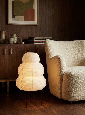 Yuki lantern beside a boucle armchair